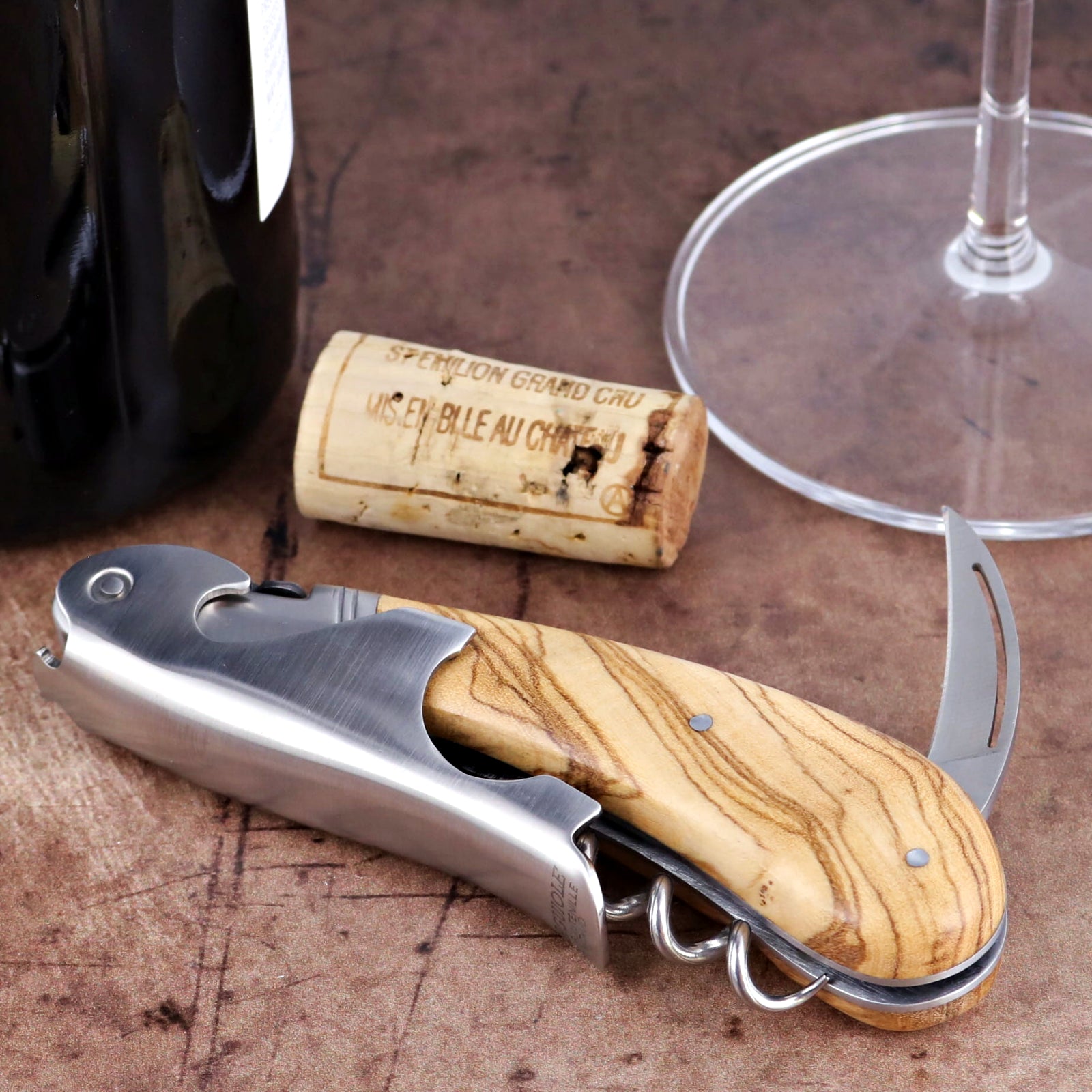 Laguiole Magnum Olive Wood Corkscrew, close-up of polished steel and natural olive wood handle.