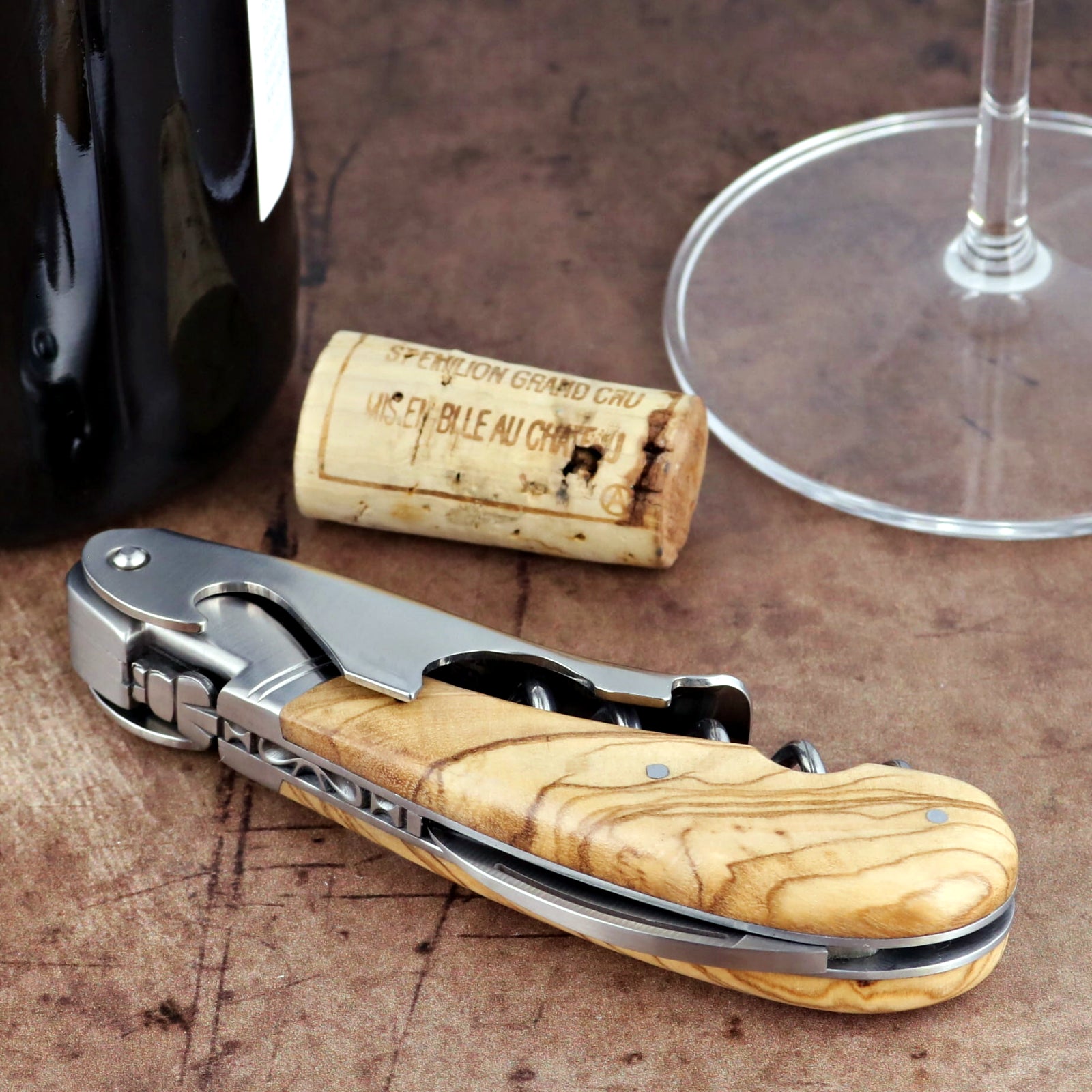 Laguiole Magnum Olive Wood Corkscrew, close-up of polished steel and natural olive wood handle.
