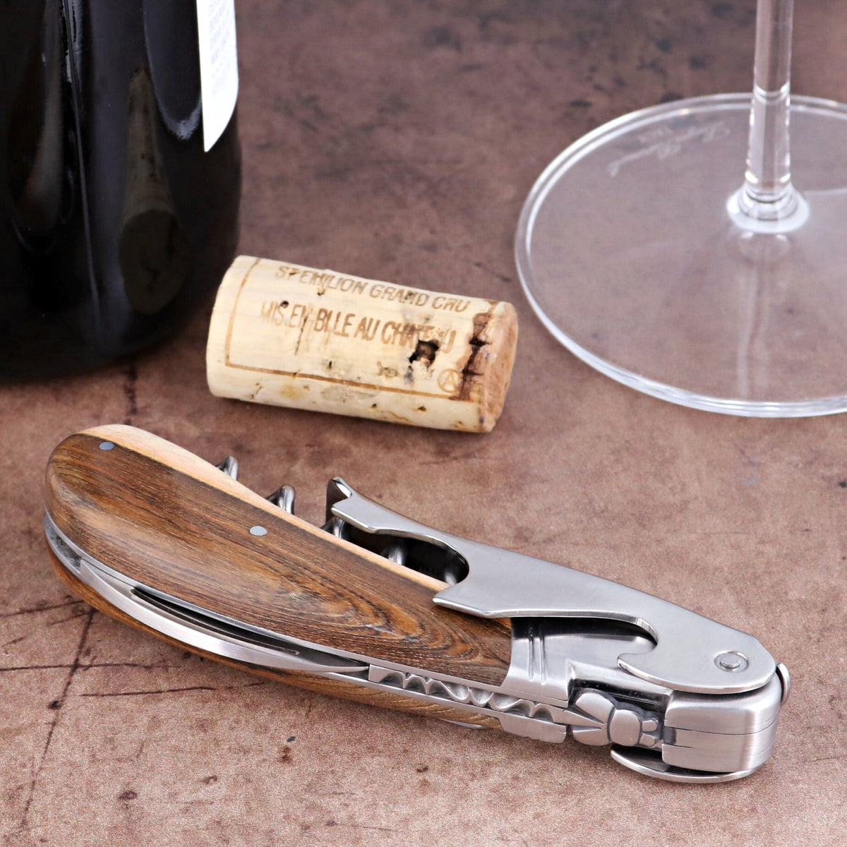 Laguiole Magnum Pistachio corkscrew, close-up of folded wood handle and stainless steel mechanism.