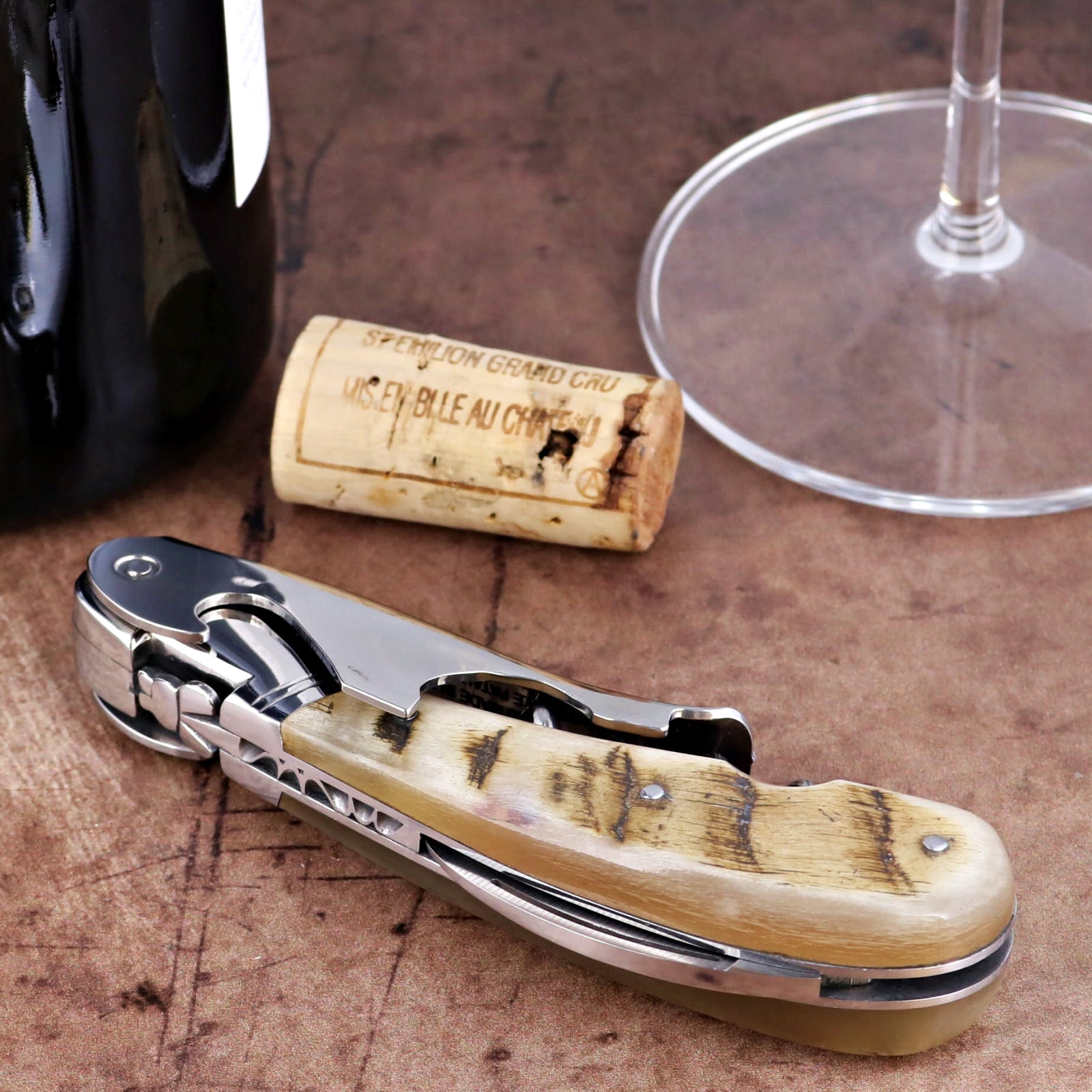 Laguiole Magnum Ram Horn Corkscrew close-up featuring a polished steel body and textured horn handle.