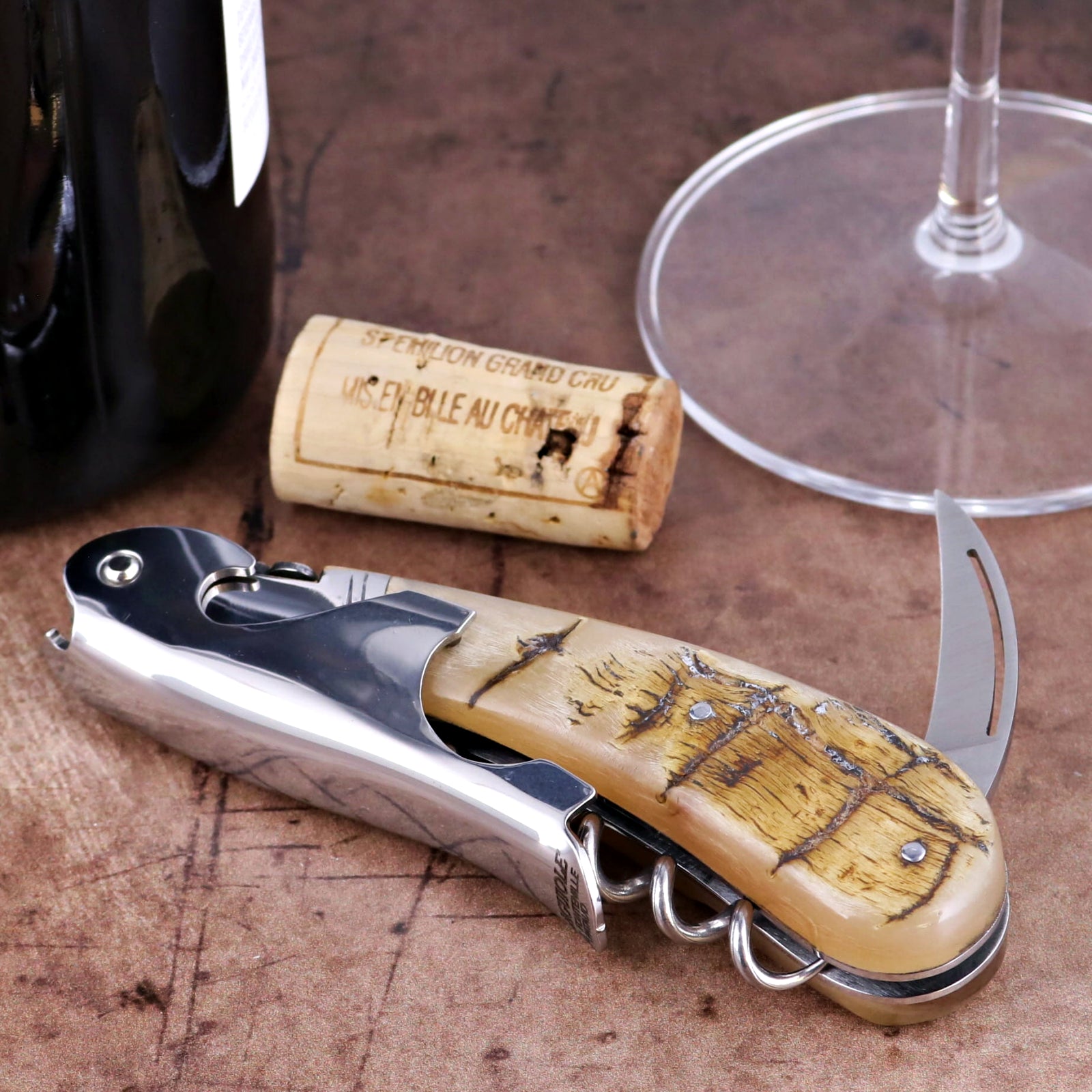 Laguiole Magnum Ram Horn Corkscrew, close-up of polished steel and textured cream horn handle.
