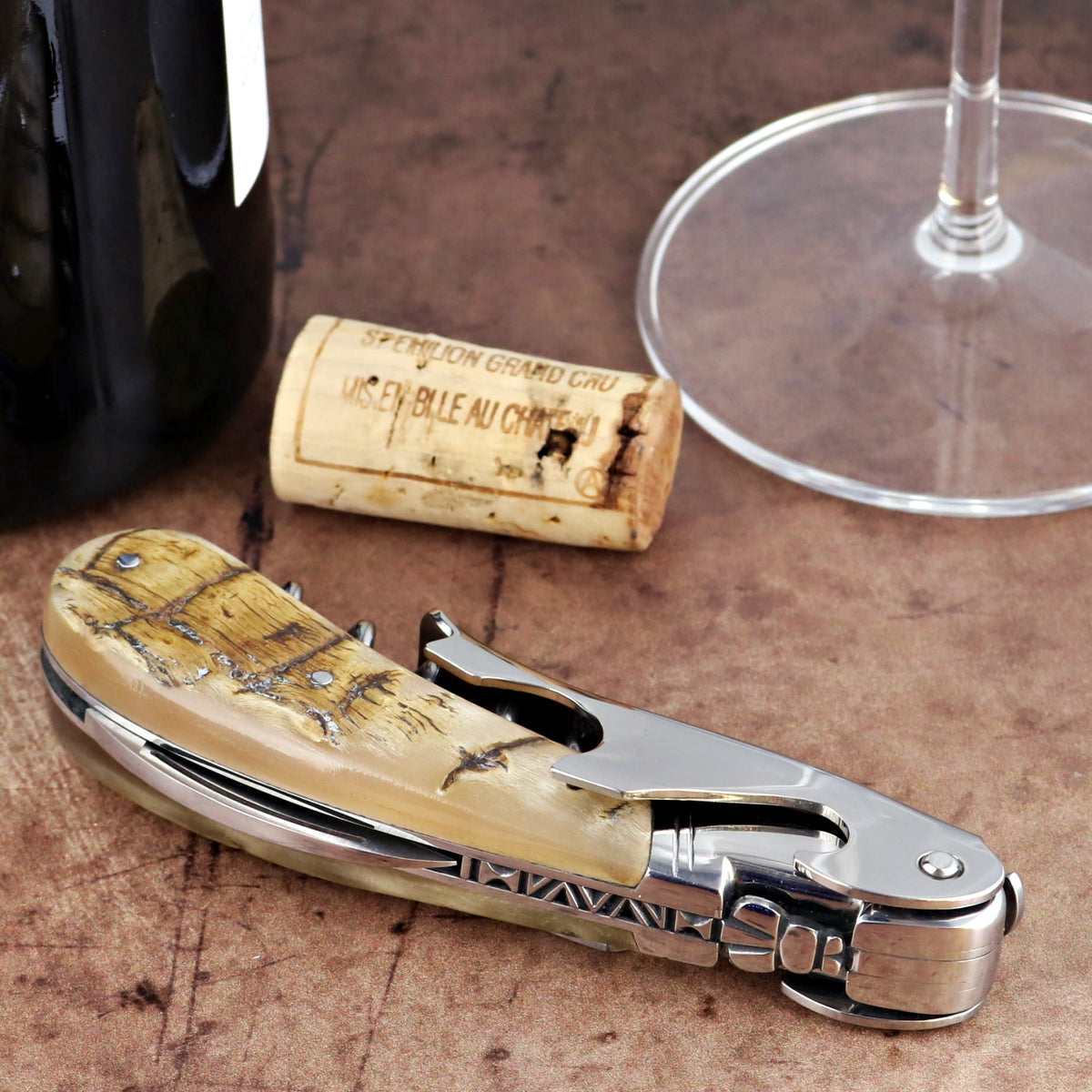 Laguiole Magnum Ram Horn Corkscrew, close-up side view showing textured cream handle and steel frame.