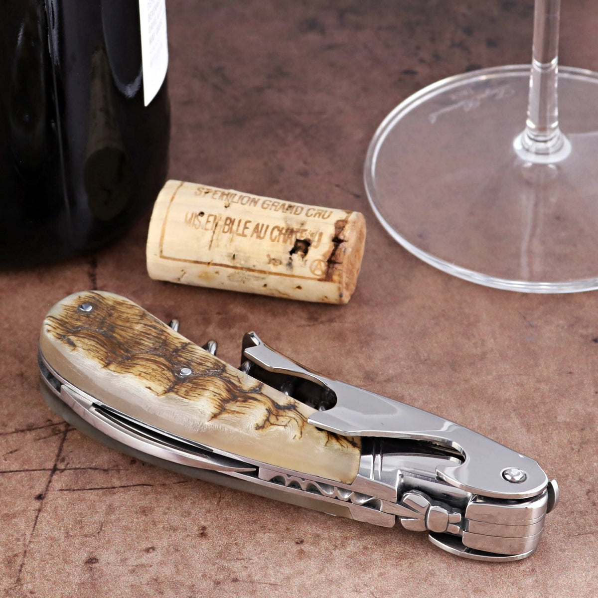 Laguiole Magnum Ram Horn Corkscrew, close-up side view showing polished steel and textured horn handle.