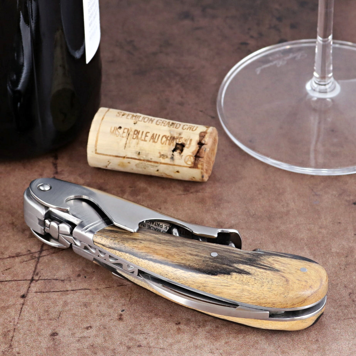 Laguiole Magnum Royal Ebony Corkscrew, close-up side view showing polished steel and wood handle.