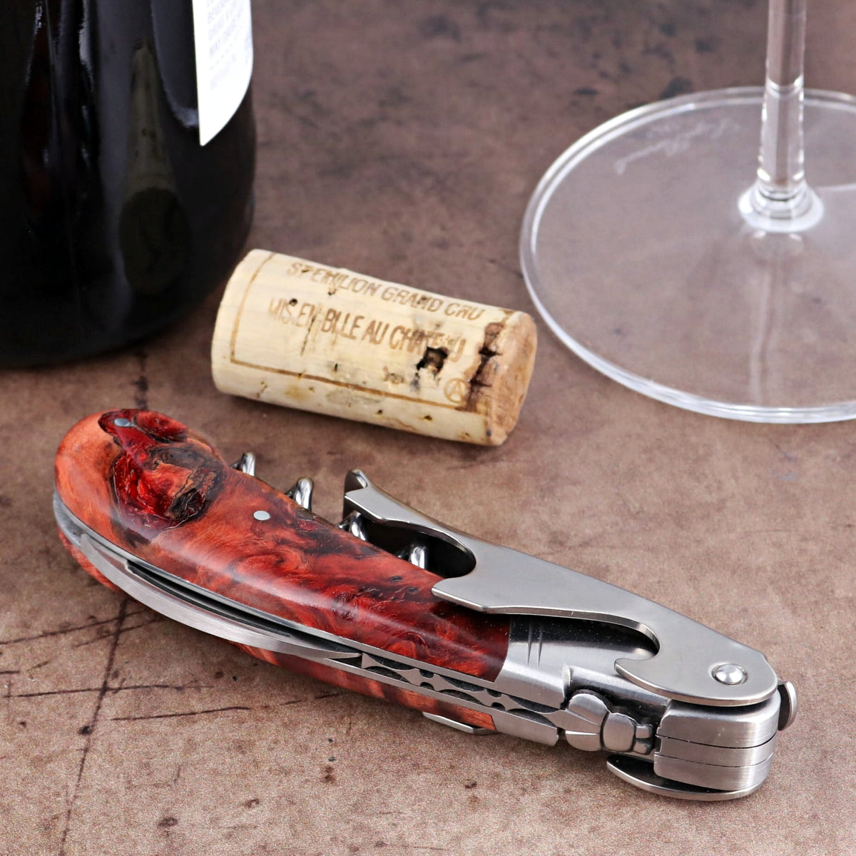 Laguiole Magnum Stained Poplar Burl Corkscrew Red, close-up of the polished red wood handle and steel.