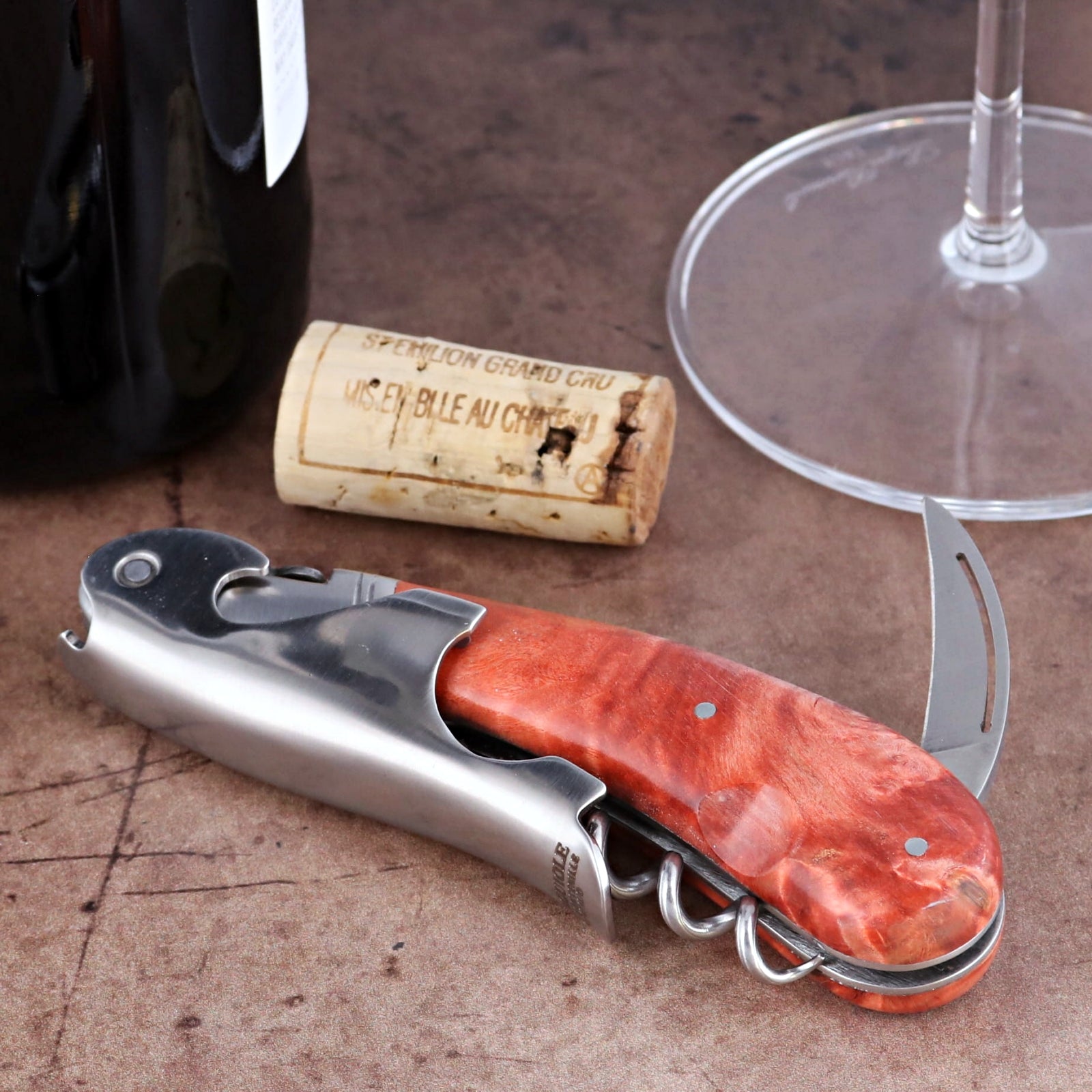 Laguiole Magnum Stained Poplar Burl Corkscrew Red, close-up of polished steel and red burl handle.