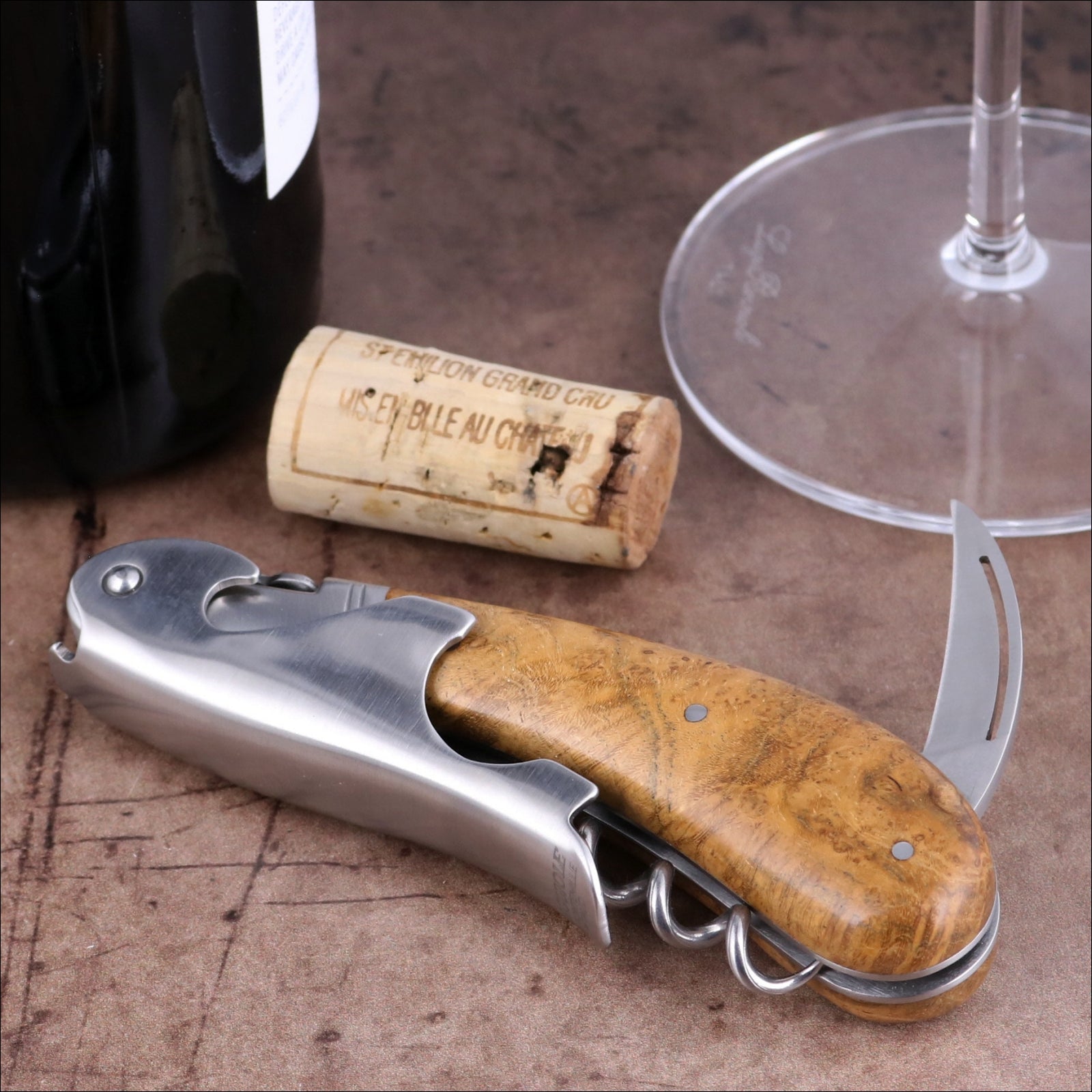 Laguiole Magnum Burled Teak Corkscrew, close-up side view showing polished steel and wood grain handle.
