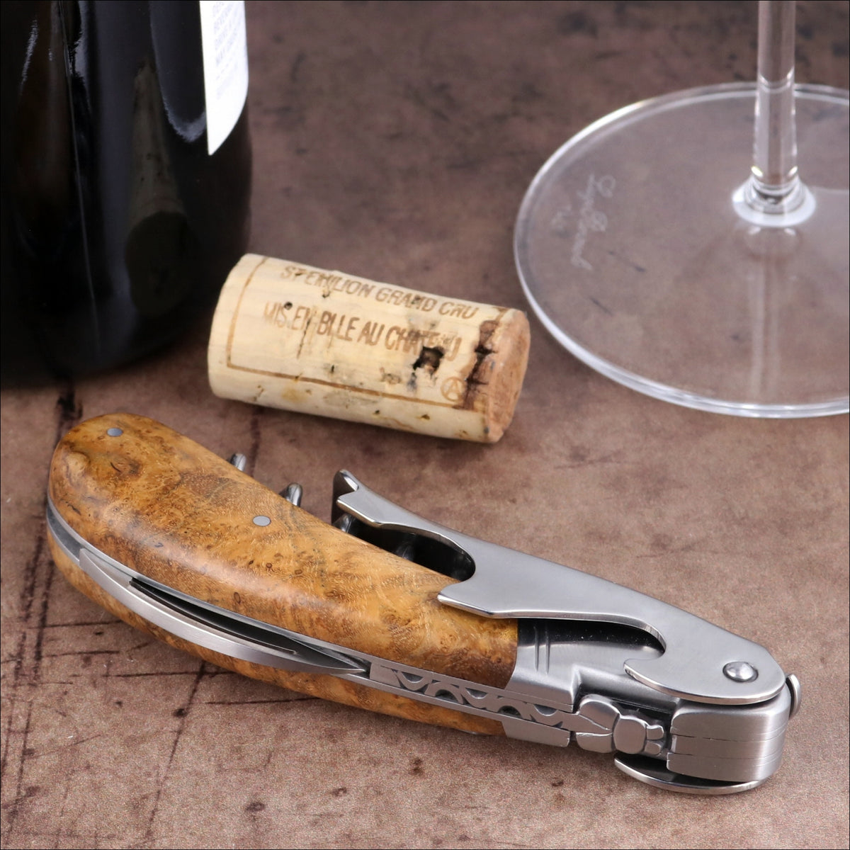 Laguiole Magnum Burled Teak Corkscrew, close-up side view featuring polished steel and wood handle.