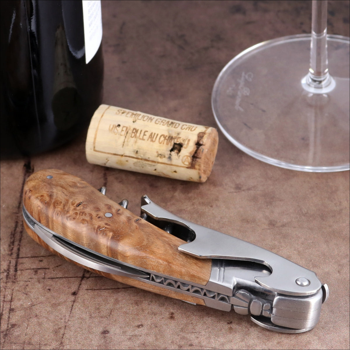 Laguiole Magnum Teak Corkscrew, close-up side view showing polished steel and natural wood grain handle.