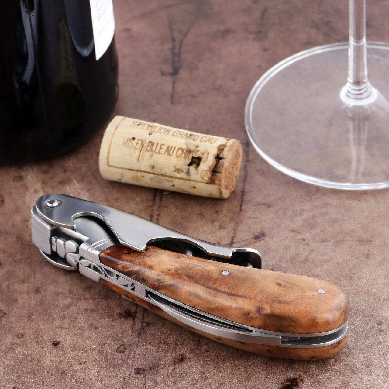 Laguiole Magnum Thuya Burl Corkscrew, close-up of the wood handle, foil cutter, and worm.