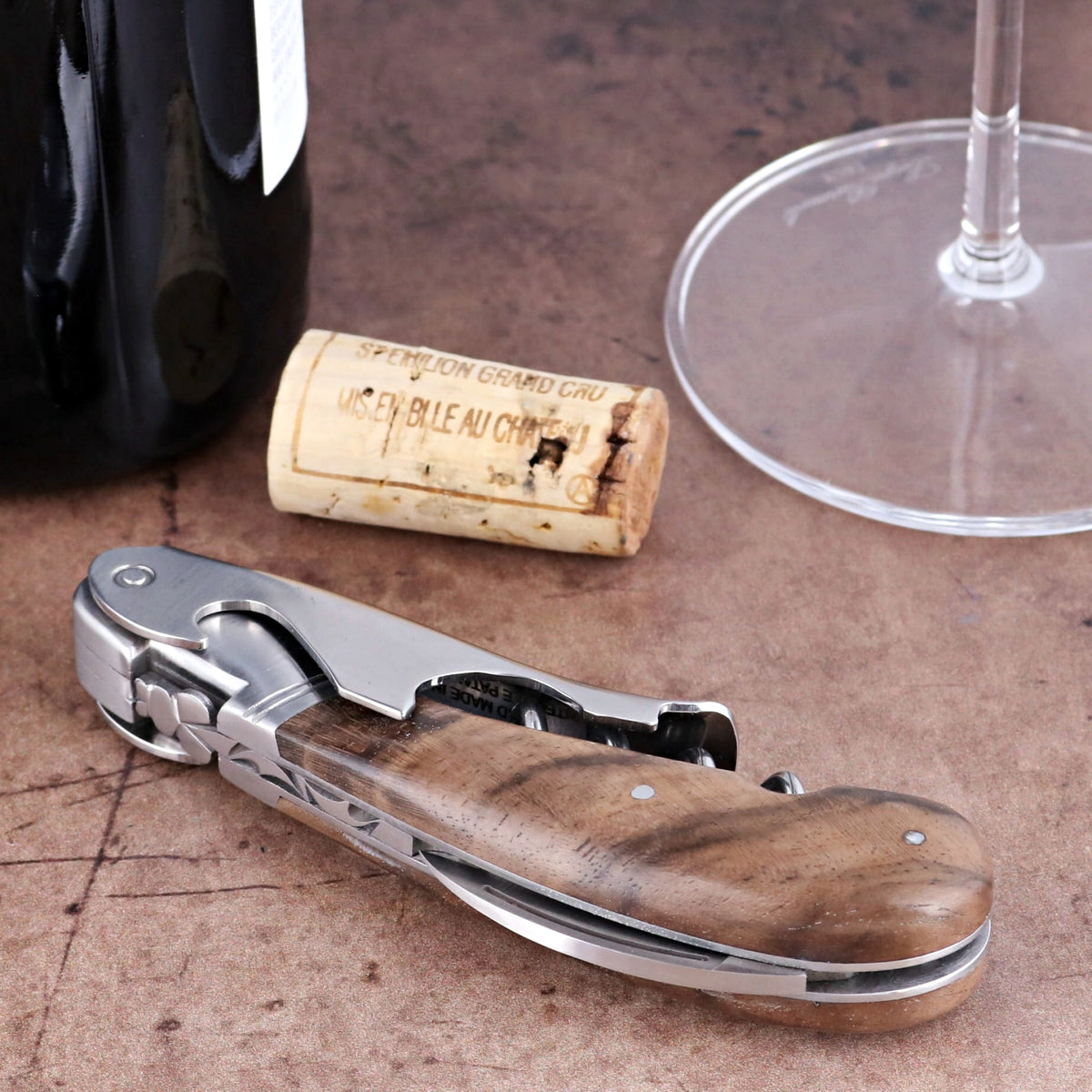 Laguiole Magnum Walnut Corkscrew, close-up of the folded stainless steel tool with wood handle.