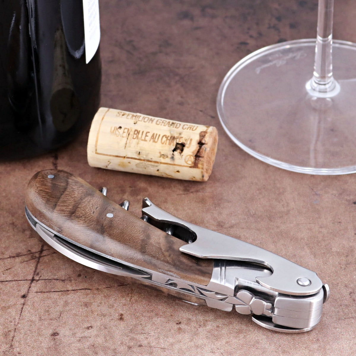 Laguiole Magnum Walnut Corkscrew close-up featuring a polished steel frame and rich walnut handle.