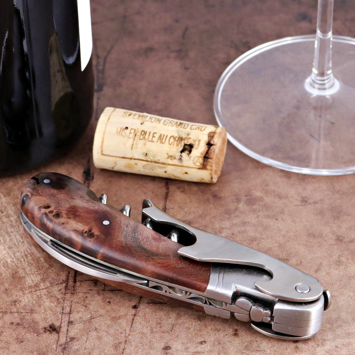Laguiole Magnum Walnut Corkscrew, close-up side view showing polished steel and rich wood grain handle.