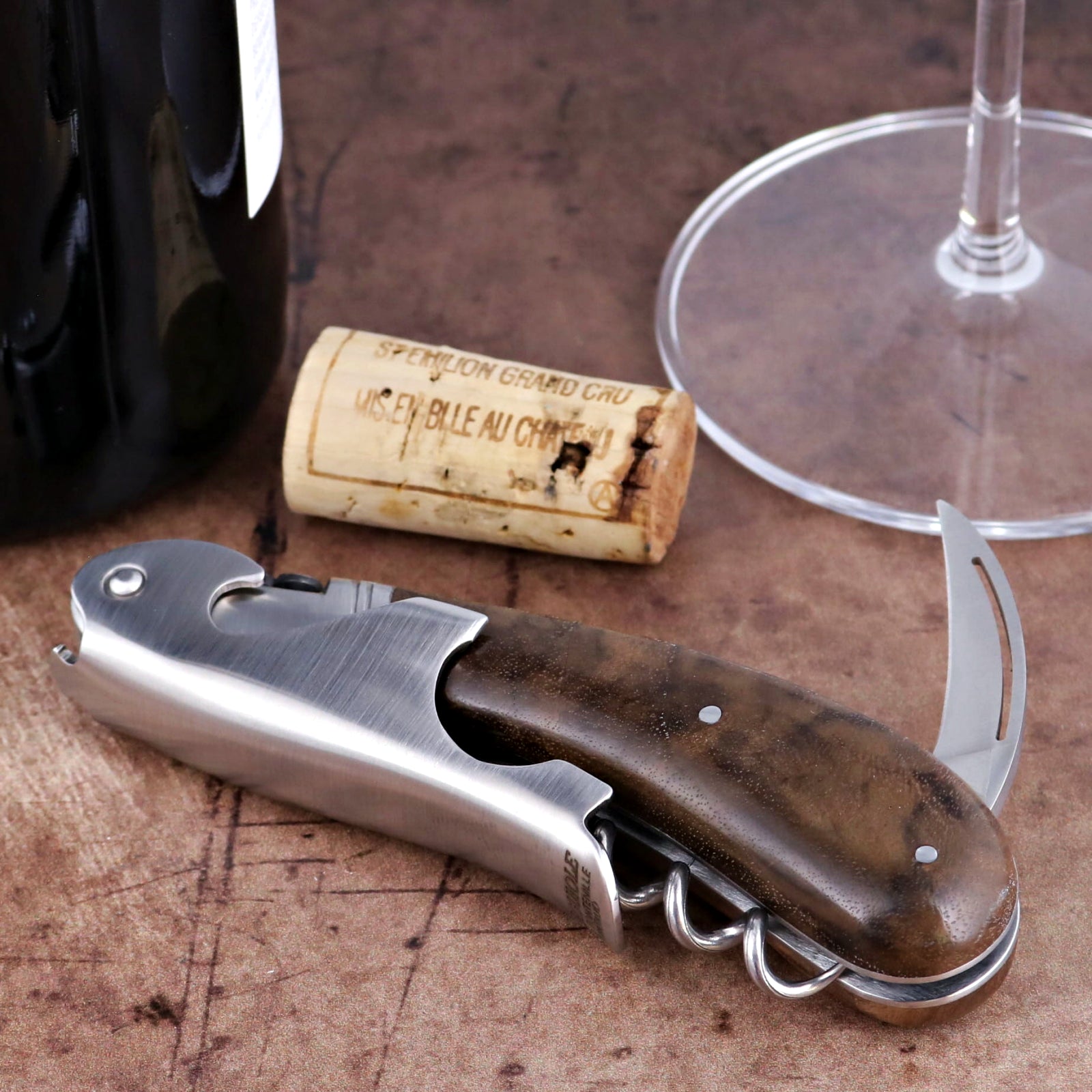 Laguiole Magnum Walnut Corkscrew close-up featuring a polished steel body and dark wood handle.