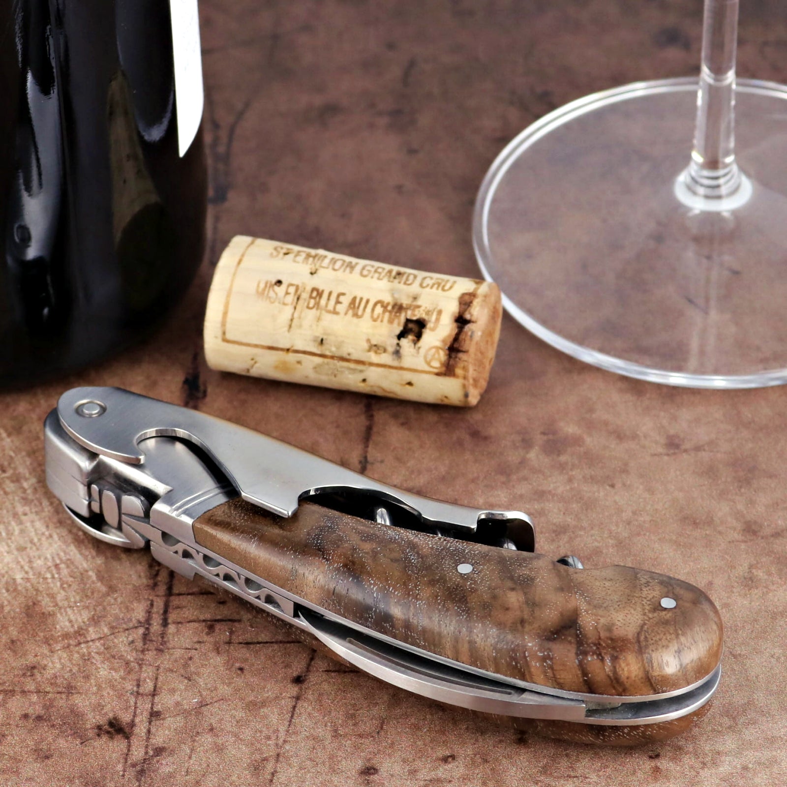 Laguiole Magnum Walnut Corkscrew close-up featuring a polished steel body and dark wood handle.