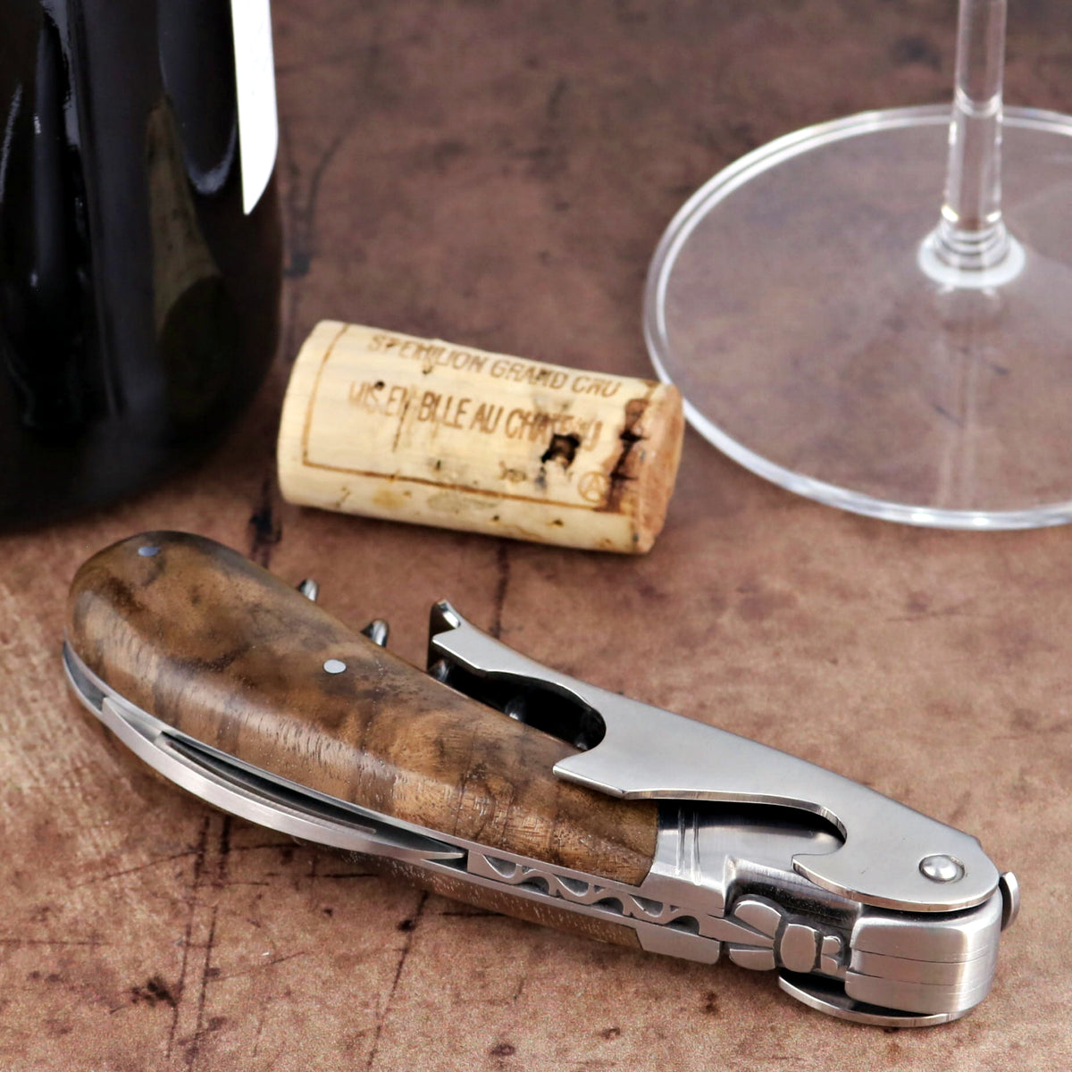 Laguiole Magnum Walnut Corkscrew close-up featuring a polished steel body and rich walnut wood handle.