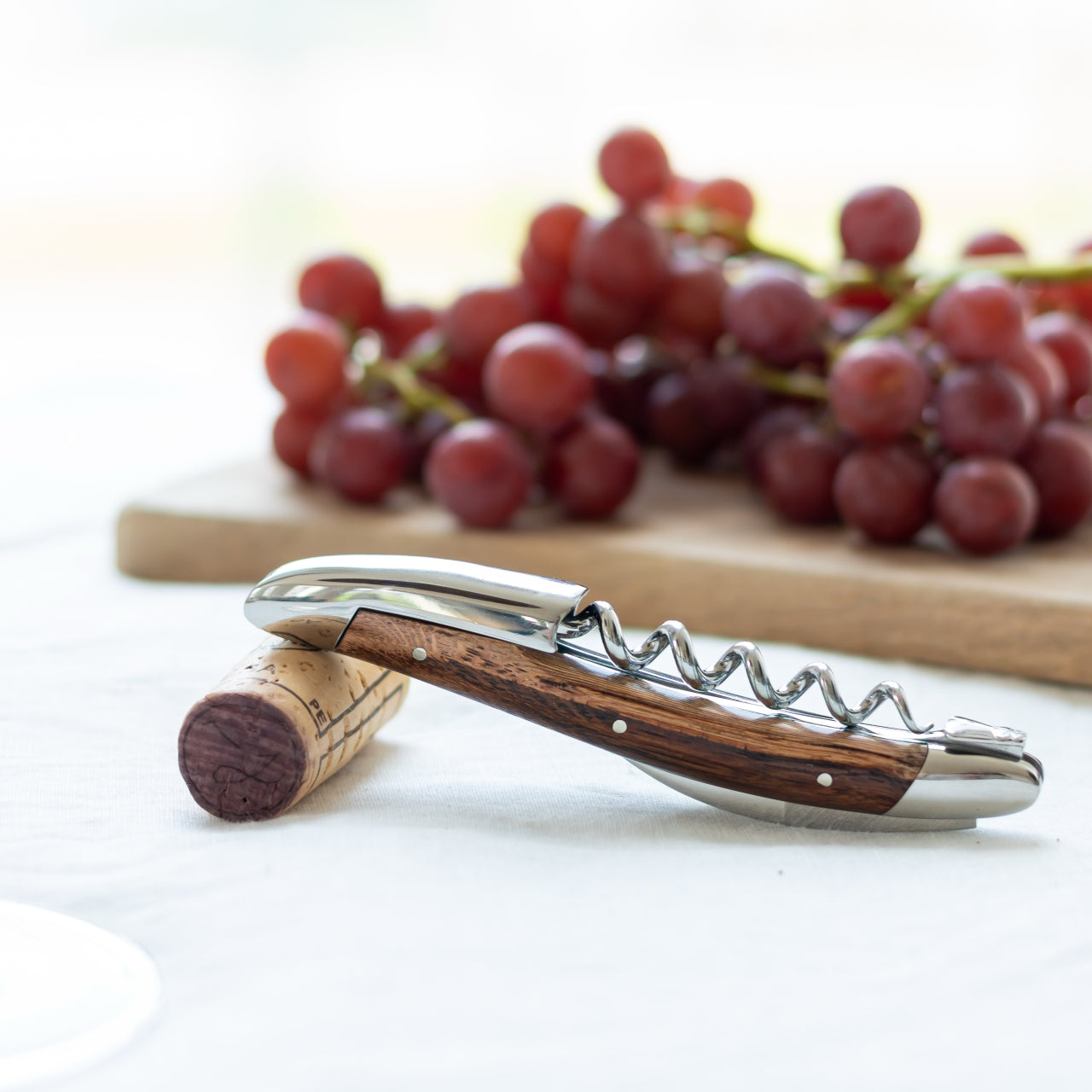 Forge de Laguiole Corkscrew Vine Stock Wood, high-angle view of two shiny steel and wood openers.