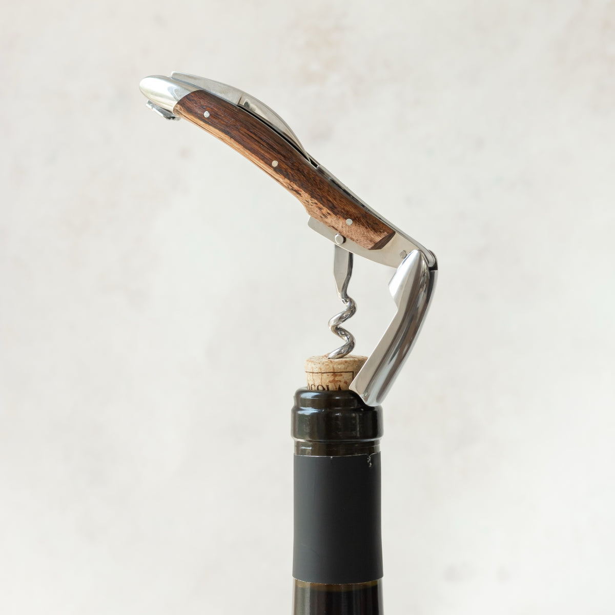 Forge de Laguiole Corkscrew Vine Stock Wood, side view showing shiny steel and dark wood handle.
