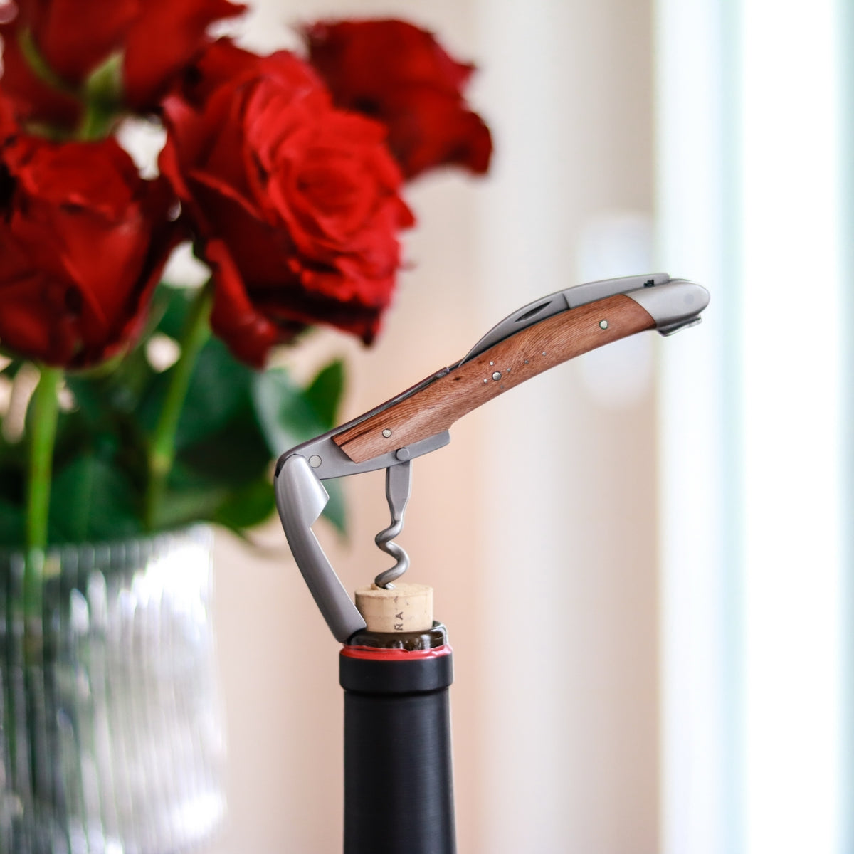 Forge de Laguiole Corkscrew, side view showing satin steel and vine stock wood handle in a wine cork.
