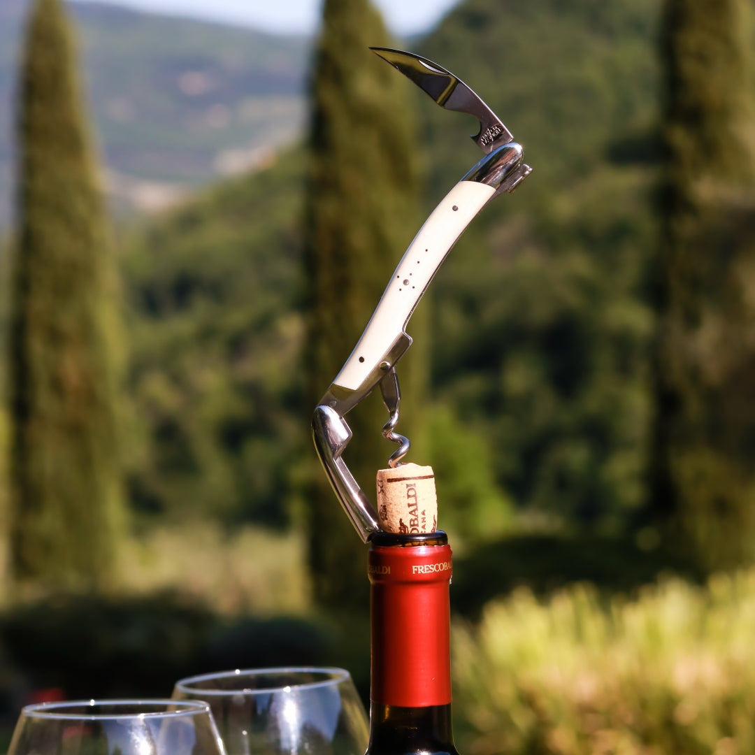 Forge de Laguiole Corkscrew Bone Handle, close-up of cream bone handle and steel tool in a wine cork.
