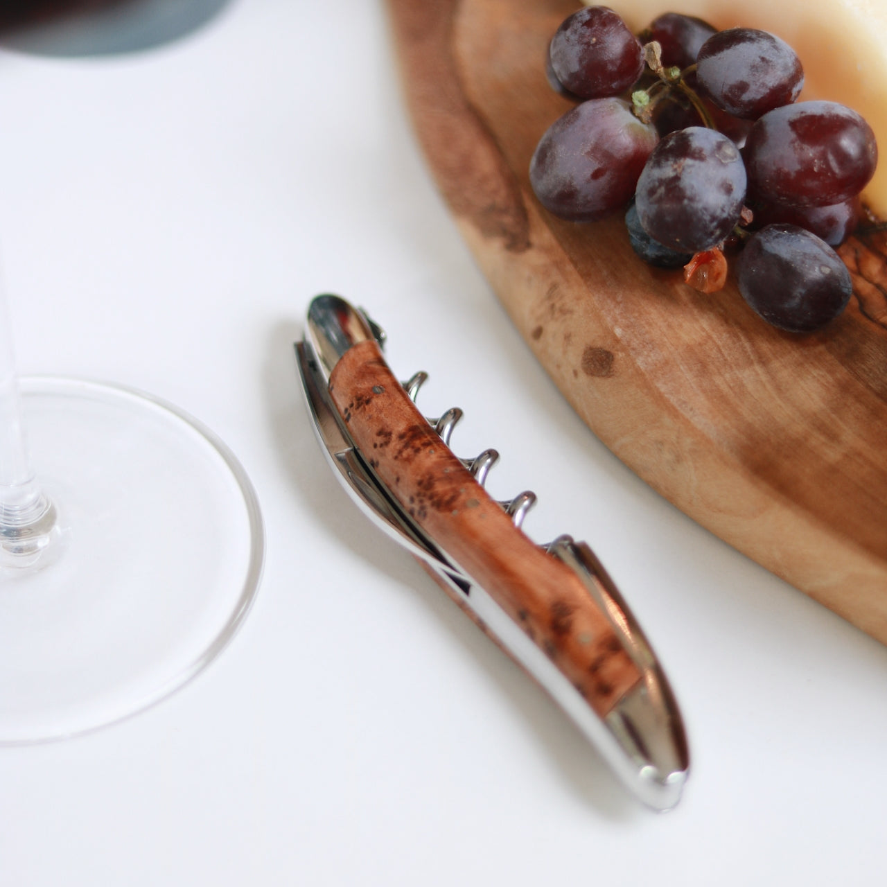 Forge de Laguiole Corkscrew Thuya Burl, top-down view showing shiny steel and wood grain with case.