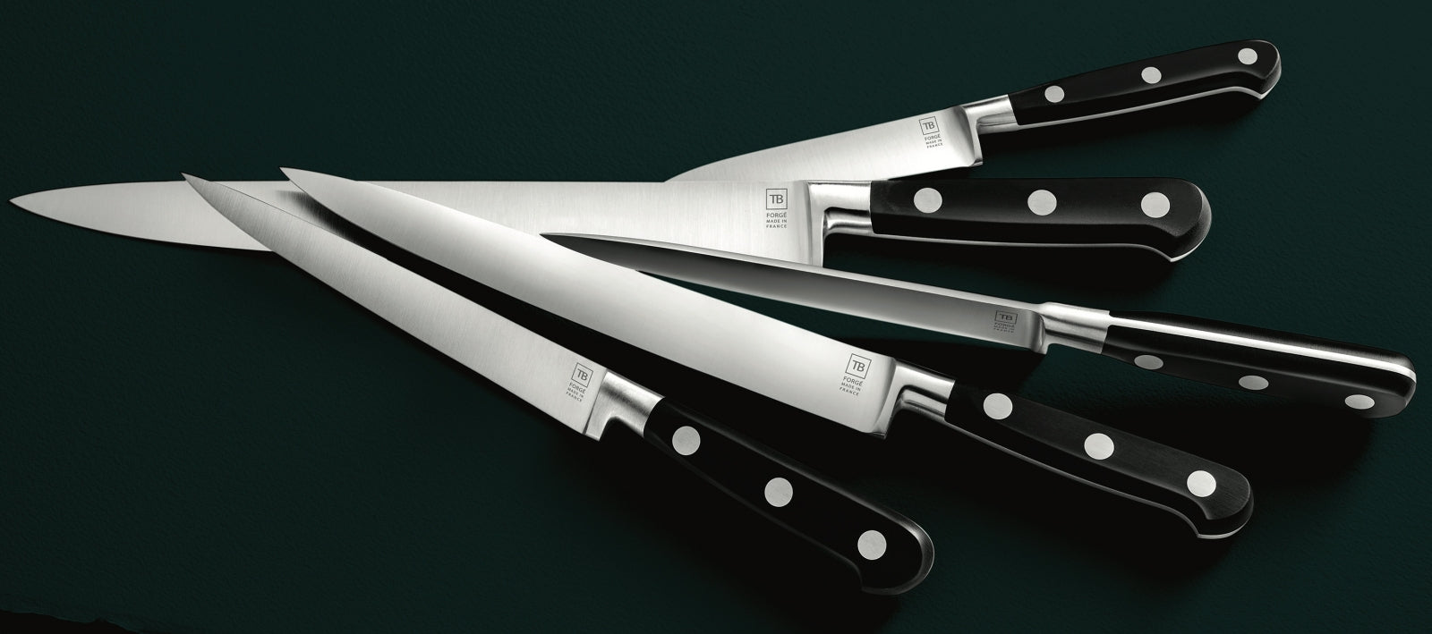 five Tarrerias-Bonjean - TB - Maestro kitchen knives on a dark green background showing several angles