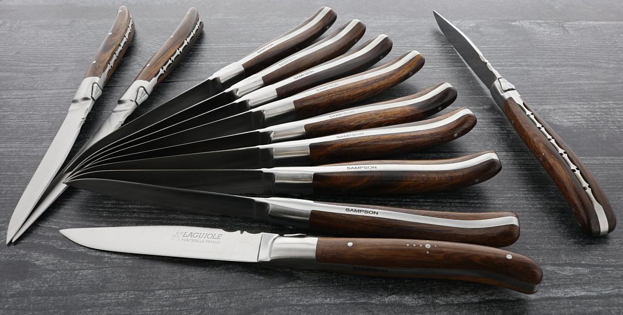 fontenille pataud steak knives ironwood handle with bottom handle engraving on a dark grey wooden background