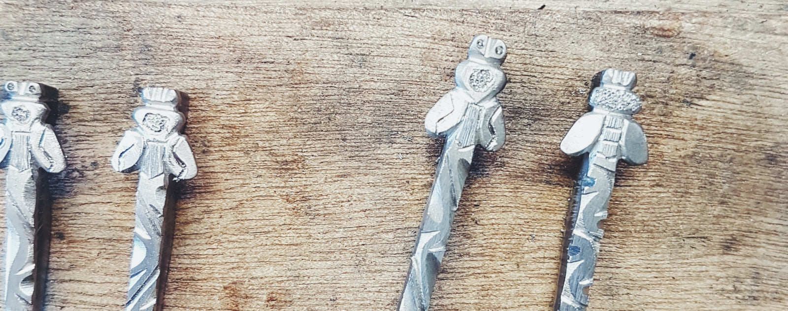 four laguiole bee and spring on a wooden board background