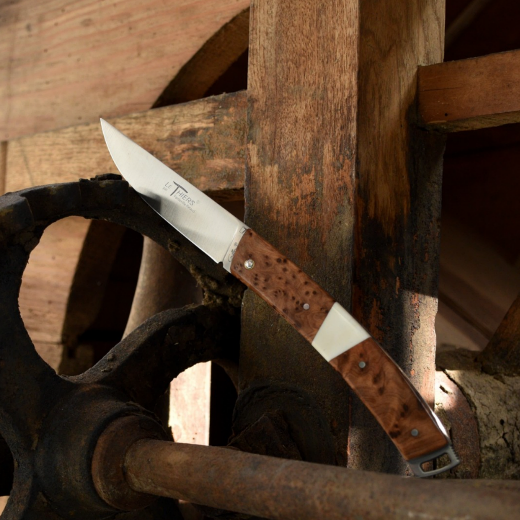 le thiers folding knife with a thuya wood handle in open position. thuya wood is a dark brown with small black dots